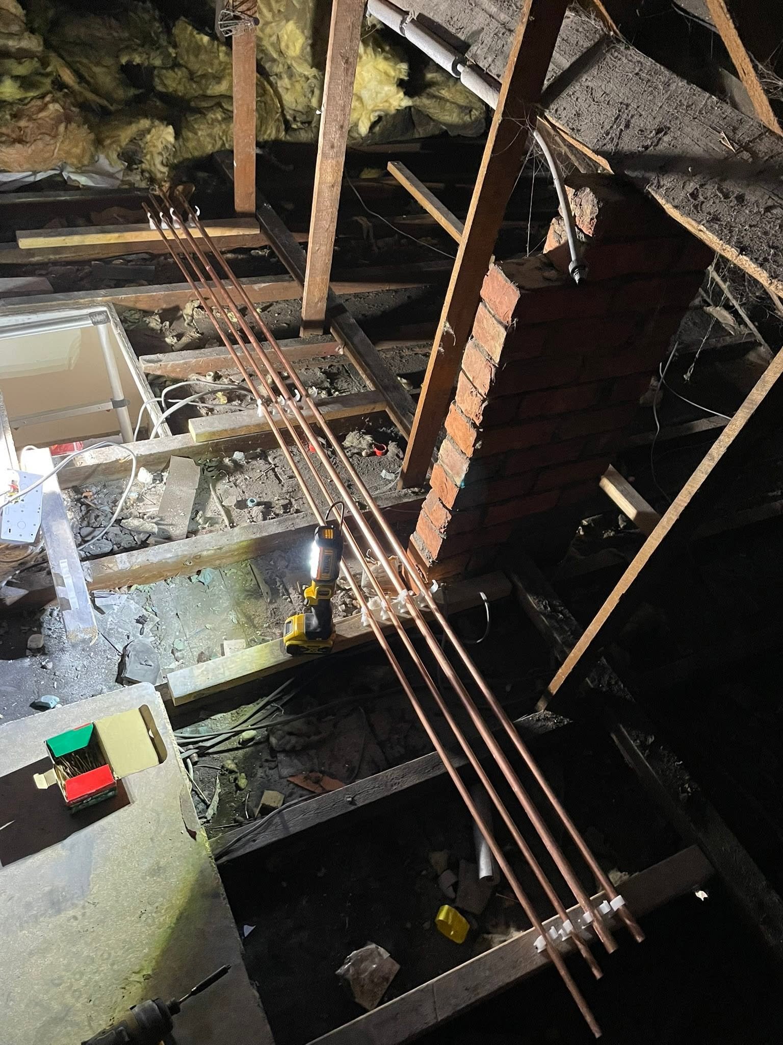 New copper pipe runs routed through the floor joists